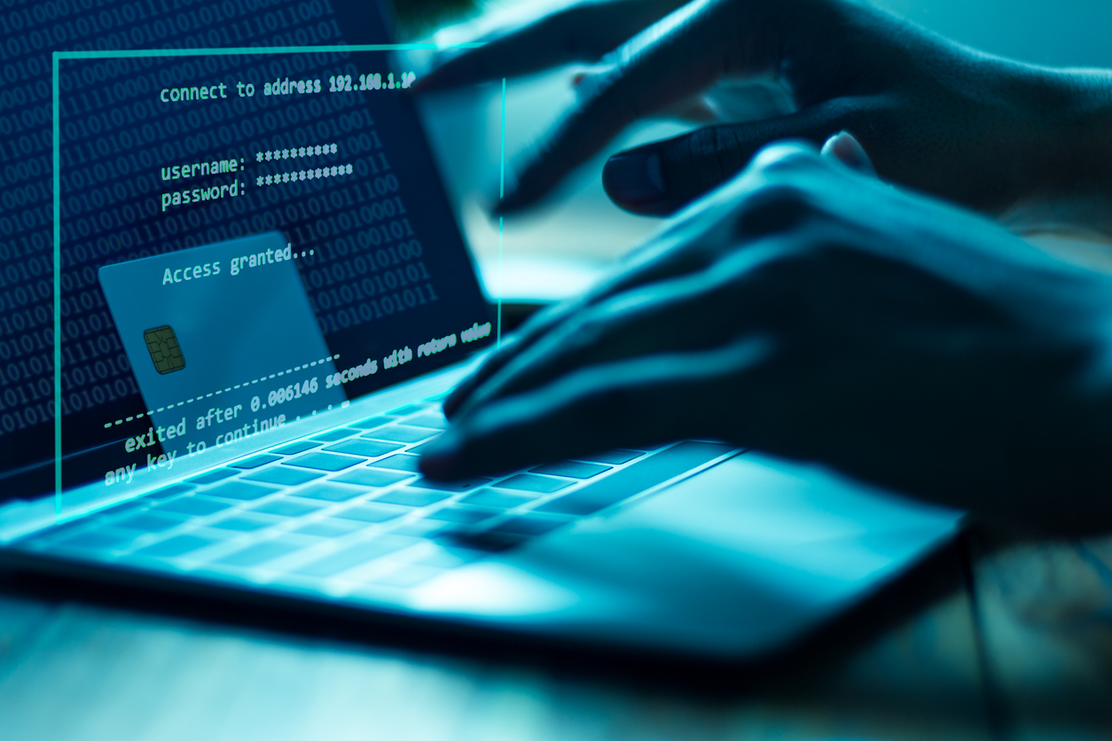 a hacker working on a laptop