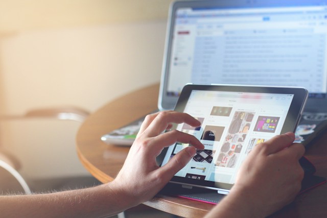 person using a tablet computer to navigate a website